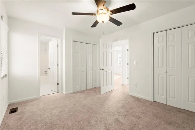 a view of empty room with ceiling fan