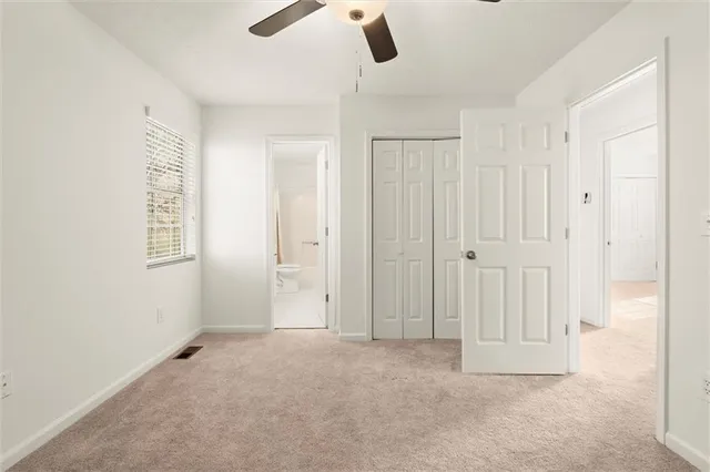 an empty room with ceiling fan