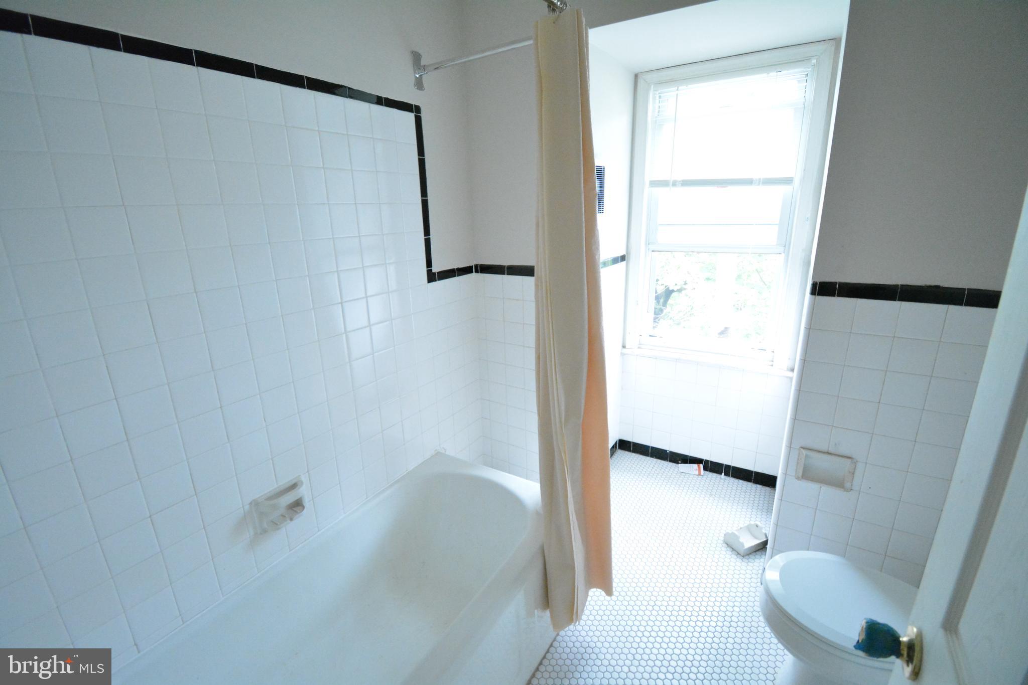 130 Manheim Street, Unit 3 Philadelphia, PA 19144 - Photo 12 of 14 a bathroom with a shower and a toilet