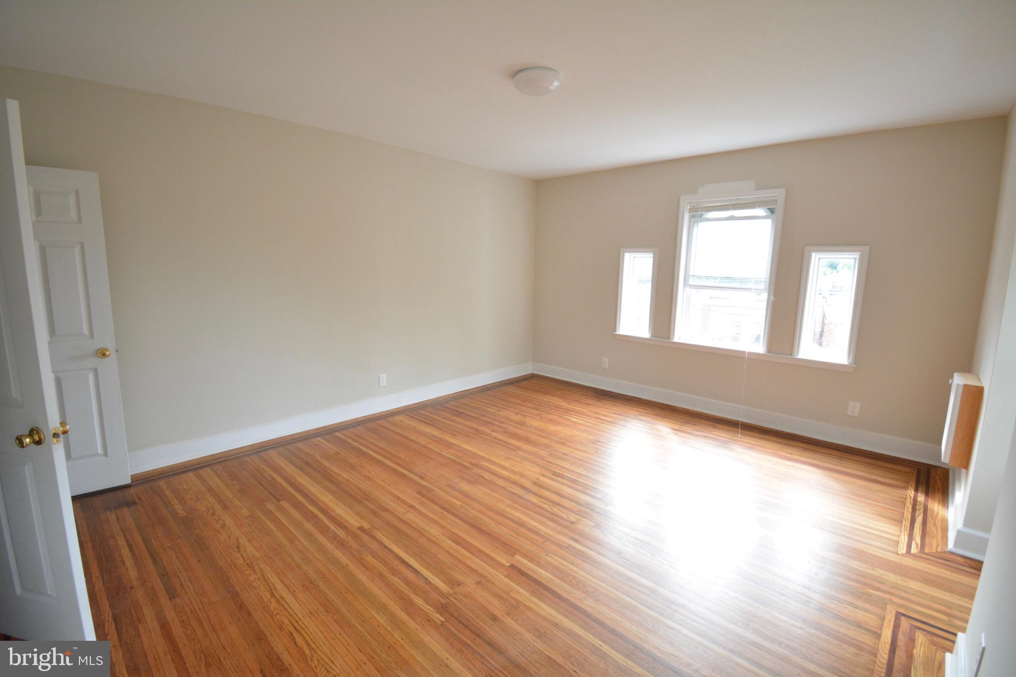 130 Manheim Street, Unit 3 Philadelphia, PA 19144 - Photo 3 of 14 a view of empty room with wooden floor and fan