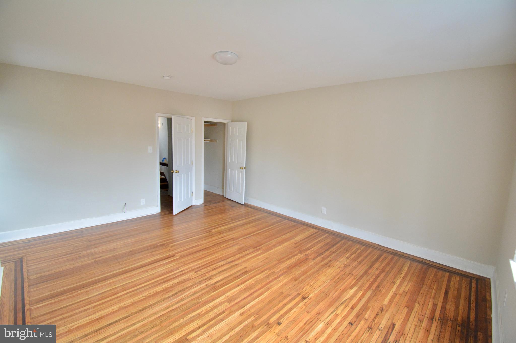 130 Manheim Street, Unit 3 Philadelphia, PA 19144 - Photo 4 of 14 a view of an empty room with wooden floor and a window