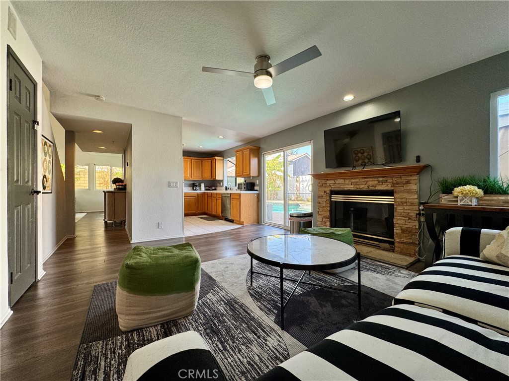 21 North Slope Lane Pomona, CA 91766 - Photo 15 of 48 a living room with furniture a flat screen tv and kitchen view