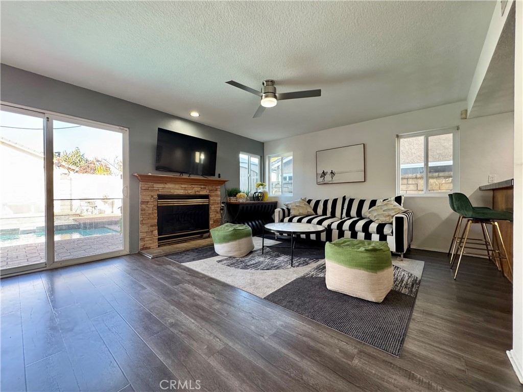 21 North Slope Lane Pomona, CA 91766 - Photo 22 of 48 a living room with furniture a fireplace and a flat screen tv