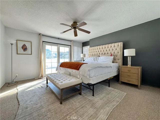 a bedroom with furniture and a large window