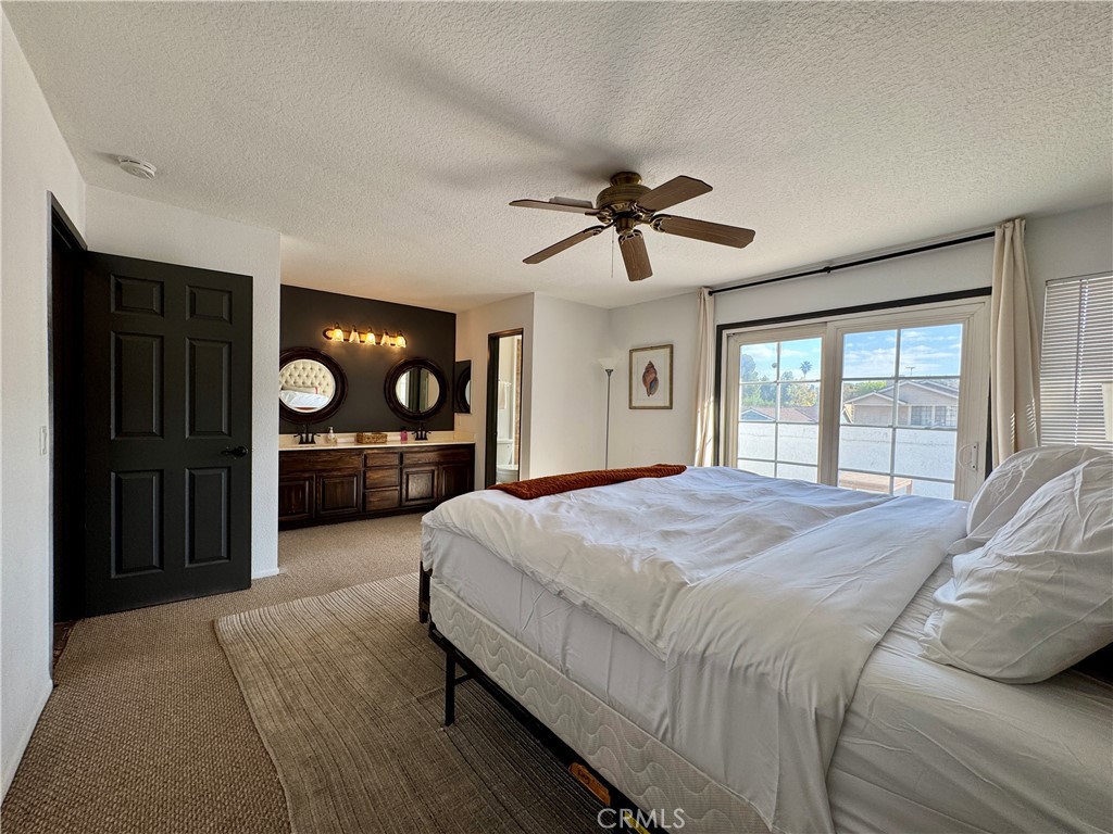 21 North Slope Lane Pomona, CA 91766 - Photo 26 of 48 a bedroom with a large bed a chandelier and dresser
