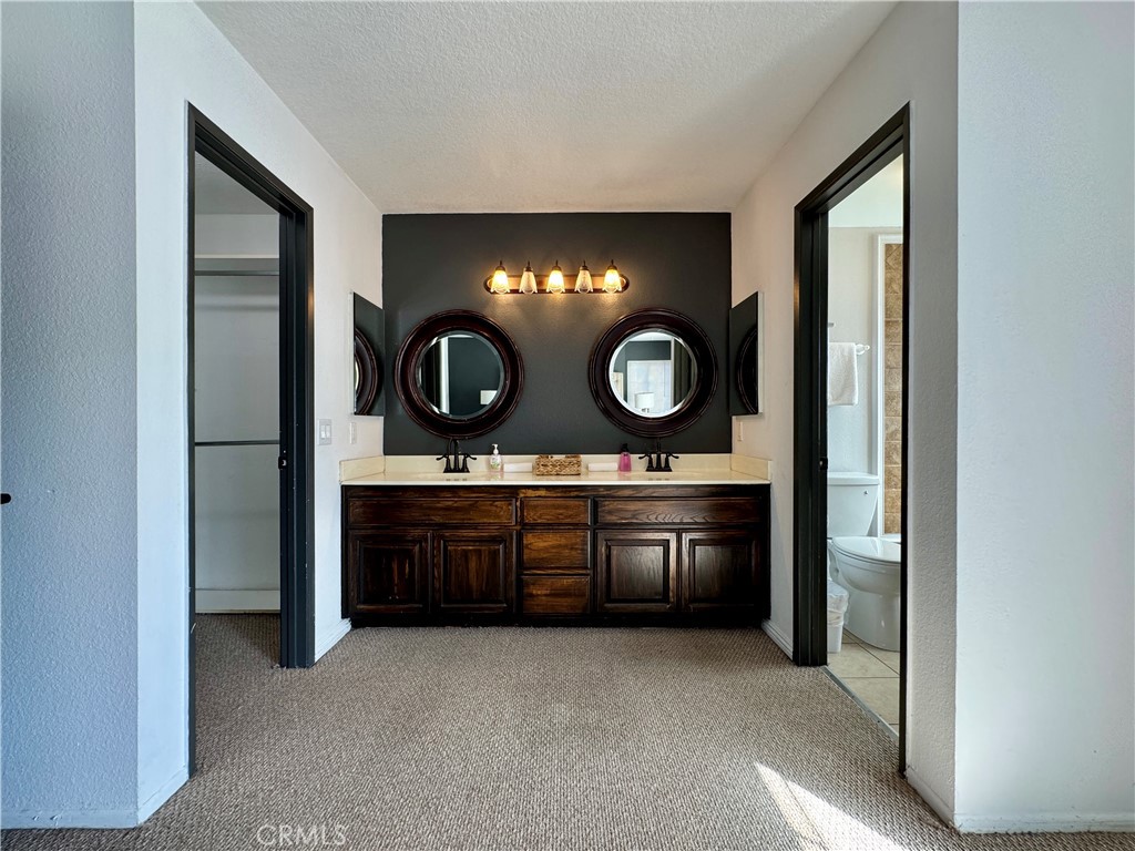 21 North Slope Lane Pomona, CA 91766 - Photo 27 of 48 a kitchen with granite countertop a stove and a sink