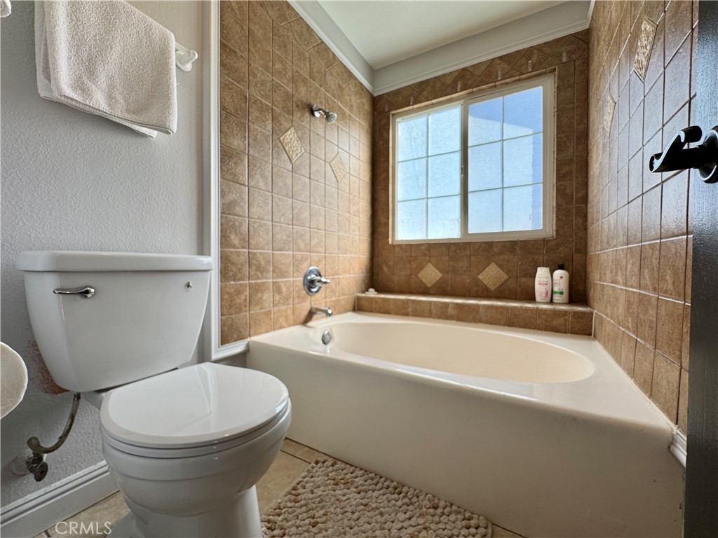21 North Slope Lane Pomona, CA 91766 - Photo 29 of 48 a white toilet sitting next to a bathtub