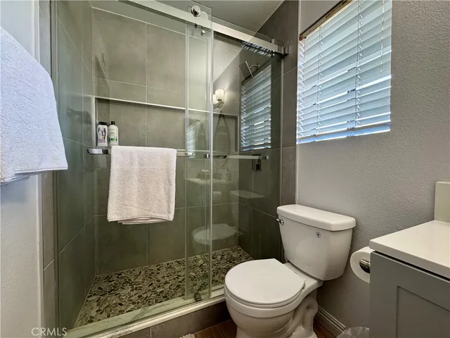 a white toilet sitting next to a bathroom sink