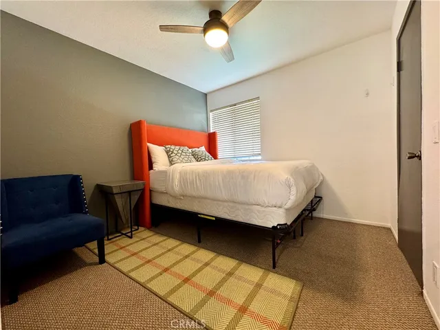 a bedroom with a bed dresser and a window