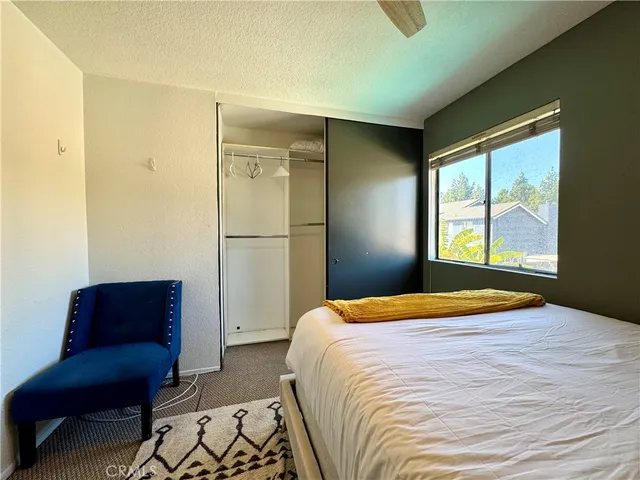 a bedroom with a bed and a couch