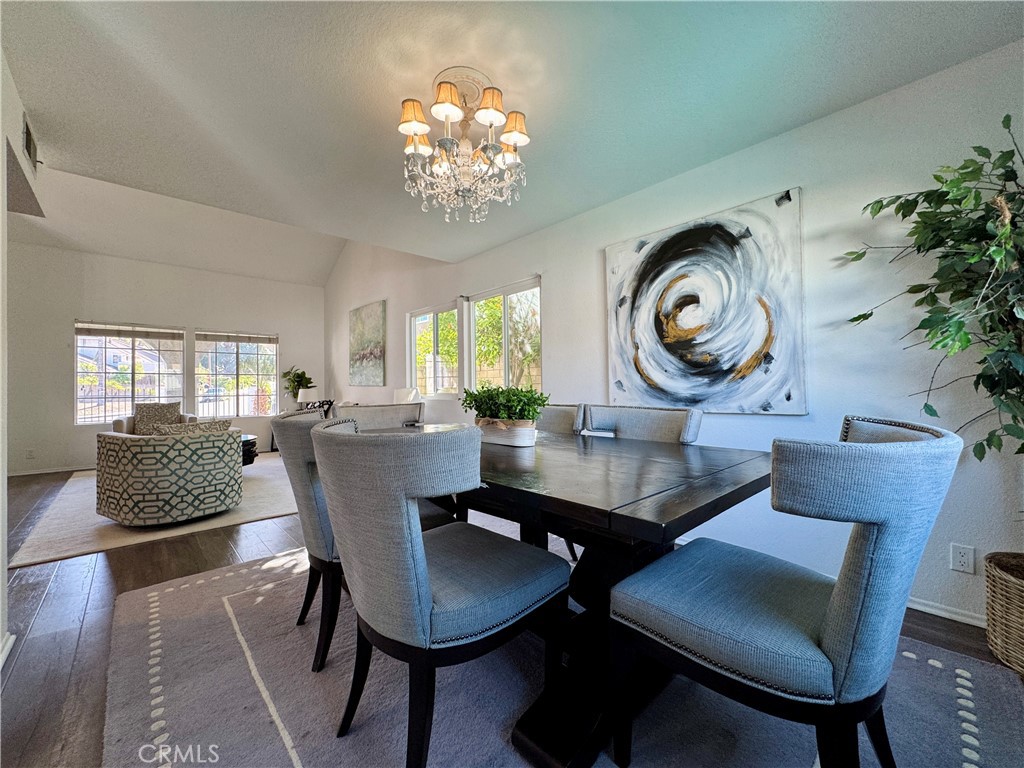 21 North Slope Lane Pomona, CA 91766 - Photo 9 of 48 a dining room with furniture a rug and a chandelier