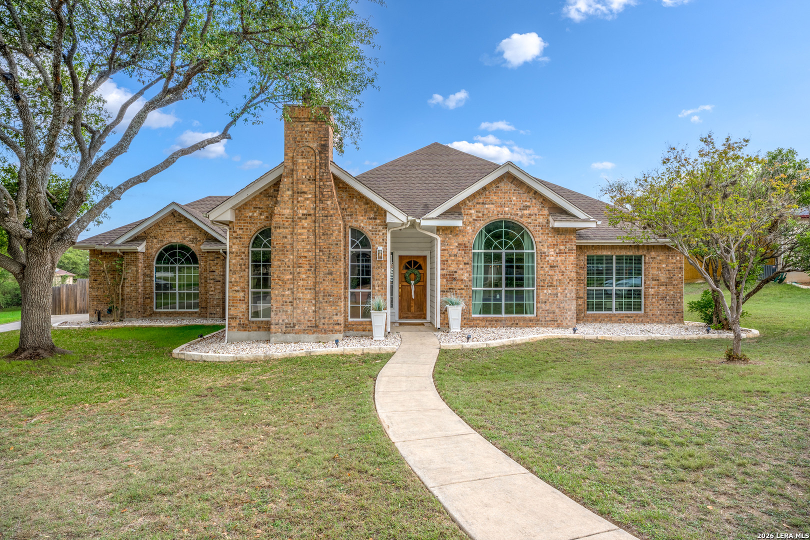 29314 Sumpter Drive Fair Oaks Ranch, TX 78015 - Photo 1 of 44 a front view of a house with a garden and trees