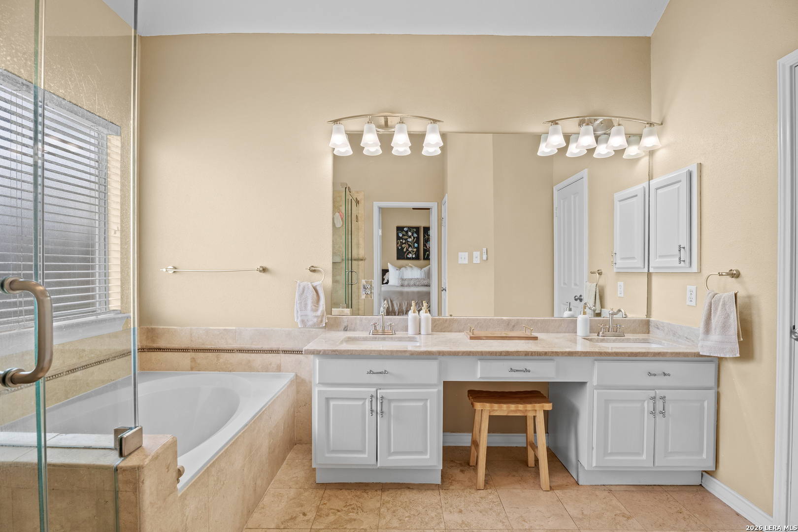 29314 Sumpter Drive Fair Oaks Ranch, TX 78015 - Photo 23 of 44 a bathroom with a double vanity sink and a bathtub