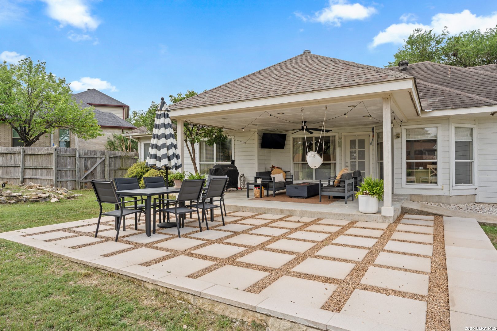 29314 Sumpter Drive Fair Oaks Ranch, TX 78015 - Photo 31 of 44 a view of a patio with table and chairs with plants and wooden fence