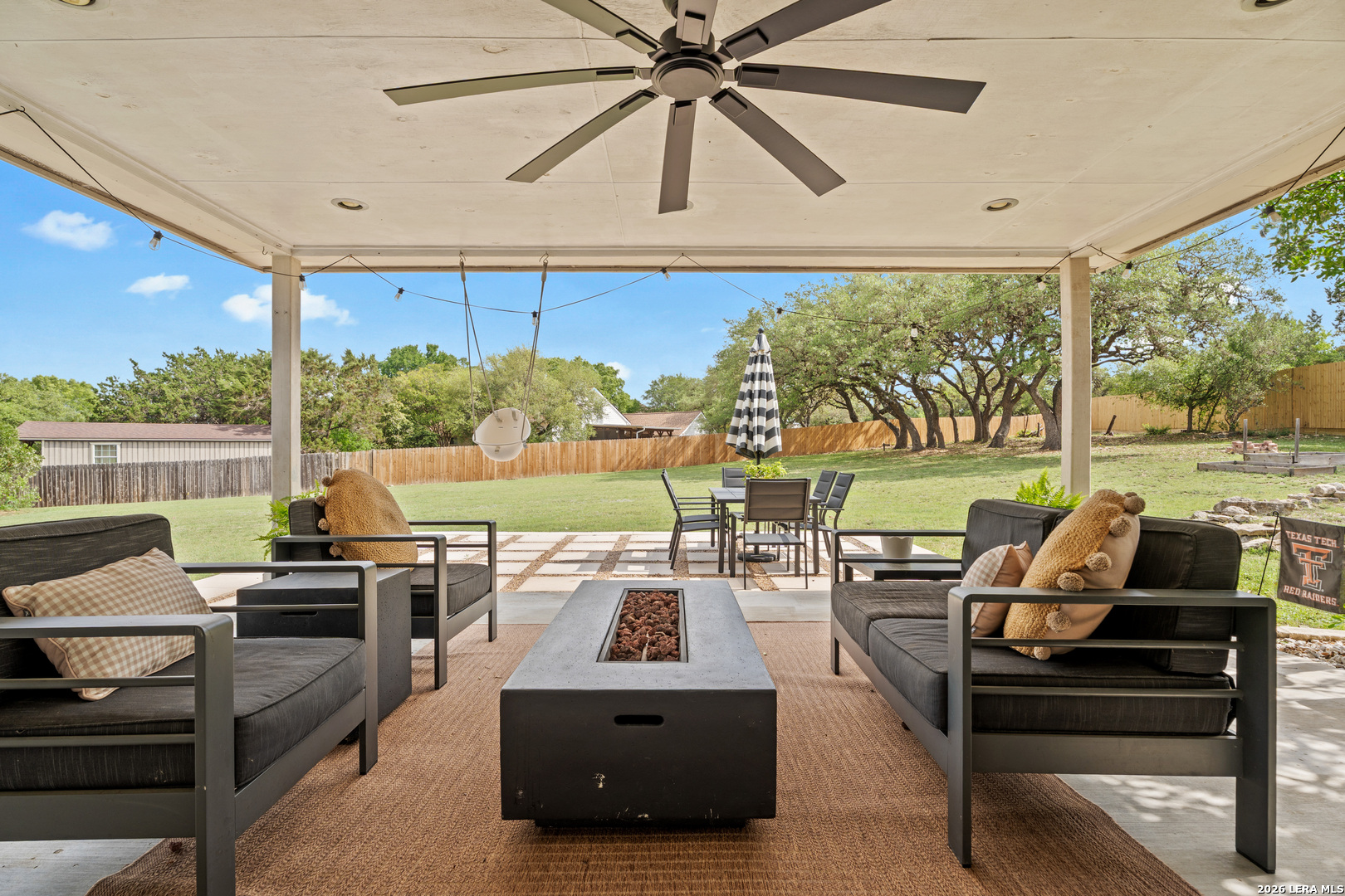 29314 Sumpter Drive Fair Oaks Ranch, TX 78015 - Photo 32 of 44 a living room with patio furniture and a floor to ceiling window