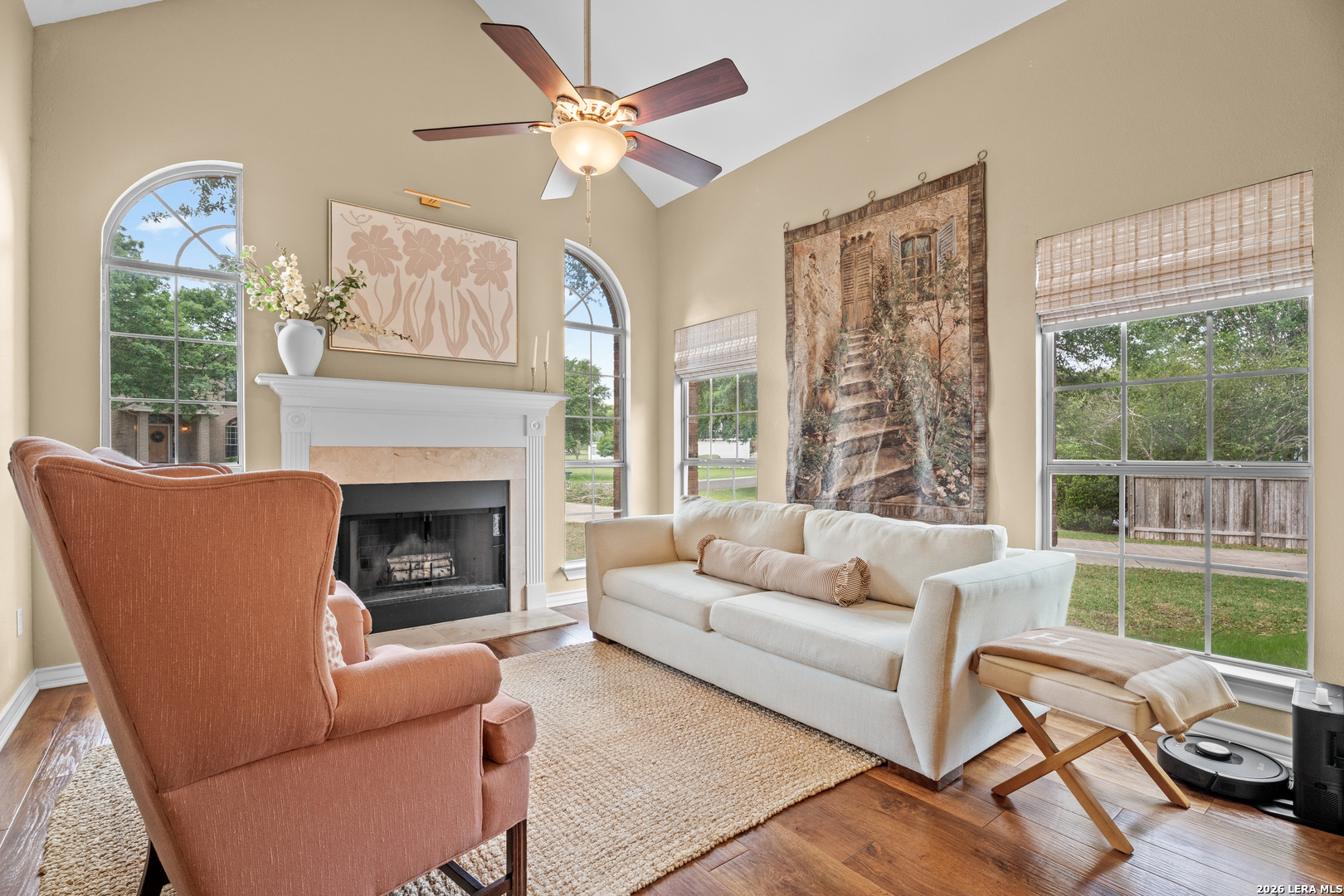 29314 Sumpter Drive Fair Oaks Ranch, TX 78015 - Photo 7 of 44 a living room with furniture a fireplace and a large window