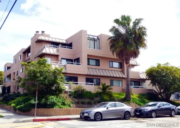 a front view of a residential apartment building with a yard