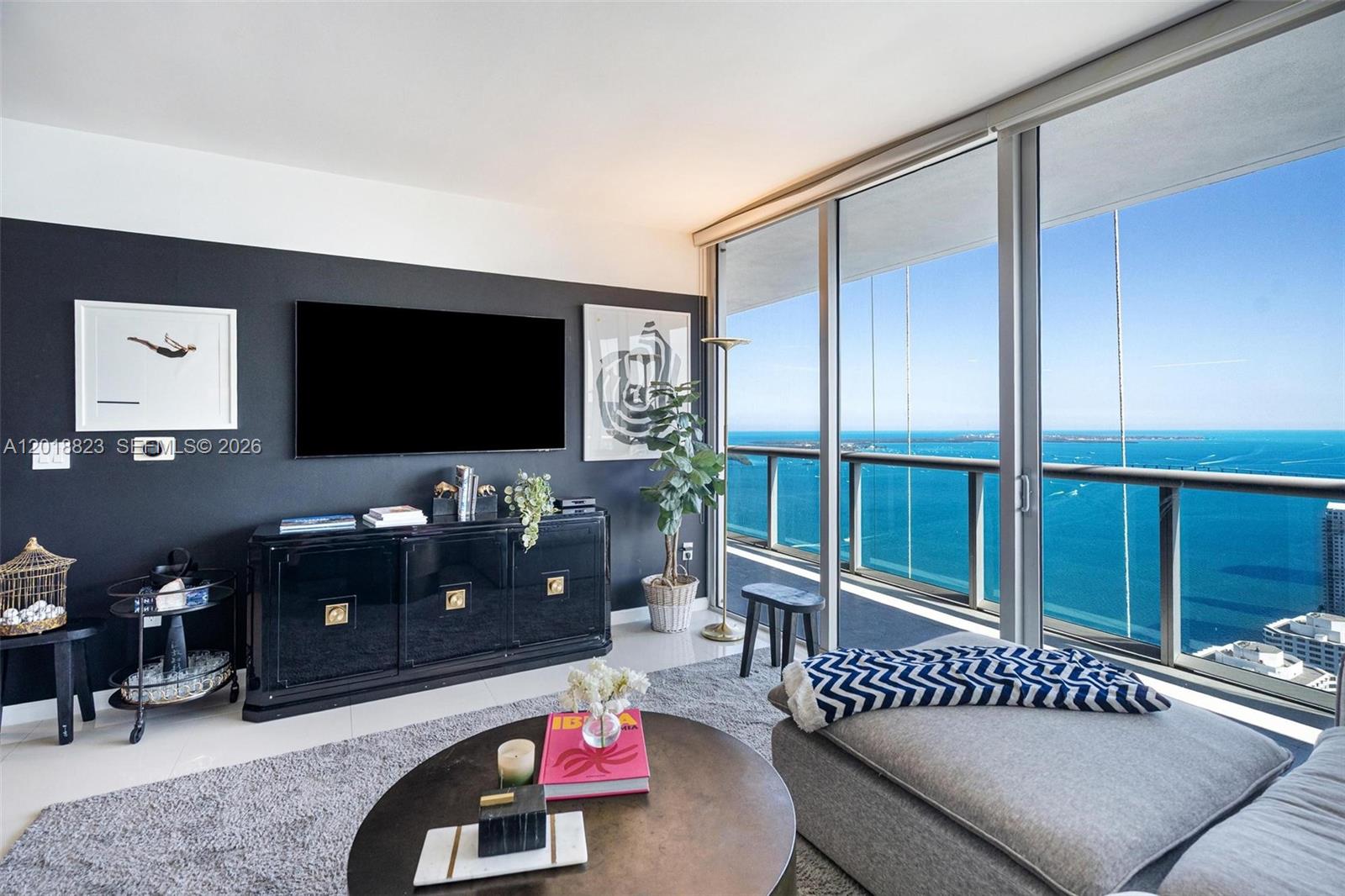 495 Brickell Avenue, Unit 4911 Miami, FL 33131 - Photo 3 of 35 a living room with furniture and a flat screen tv