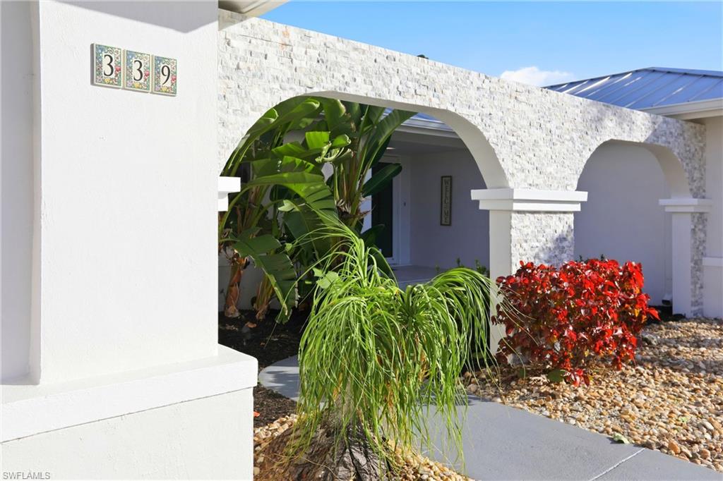 339 Landmark Street Marco Island, FL 34145 - Photo 36 of 50 Property entrance featuring stone siding and stucco siding