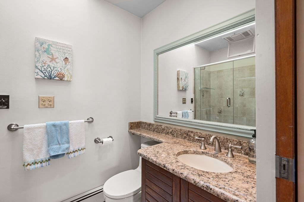 22 Little Neck Road Ipswich, MA 01938 - Photo 23 of 37 a bathroom with a granite countertop sink a mirror and a toilet