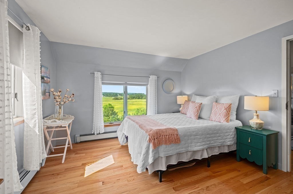22 Little Neck Road Ipswich, MA 01938 - Photo 29 of 37 a bedroom with a bed and a table in it