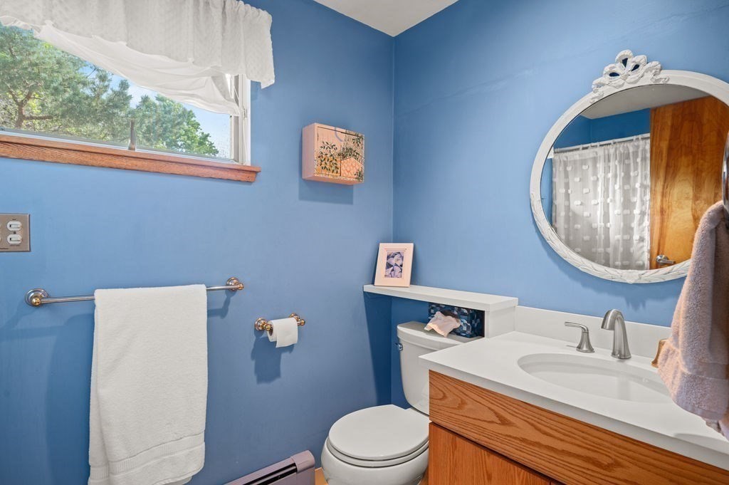22 Little Neck Road Ipswich, MA 01938 - Photo 31 of 37 a bathroom with a toilet a sink a mirror and a window