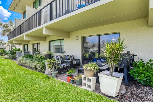 a front view of a house with porch and garden