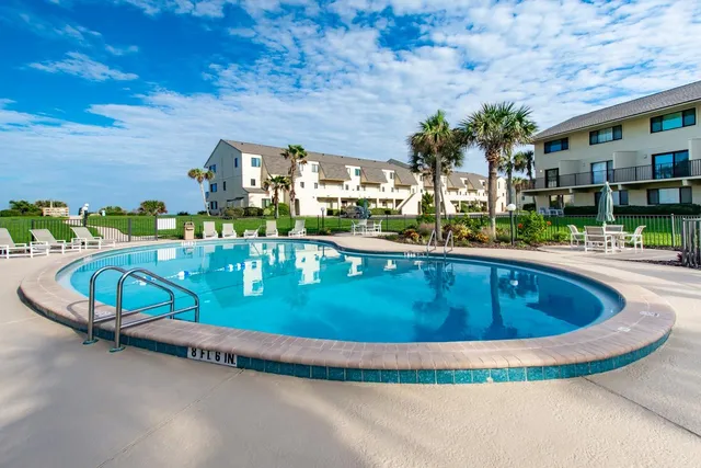 a view of swimming pool with outdoor seating