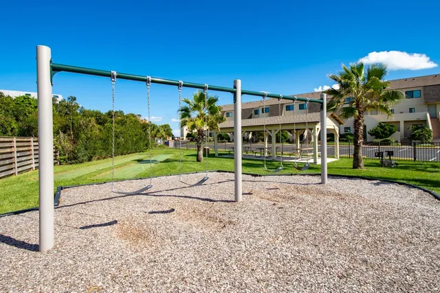 a view of a house with a yard and table and chairs