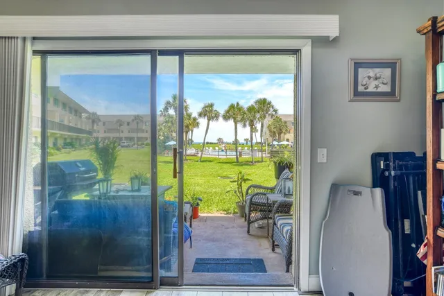 a view of a room with a large window with swimming pool