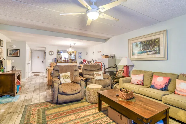 a living room with furniture a rug and a chandelier