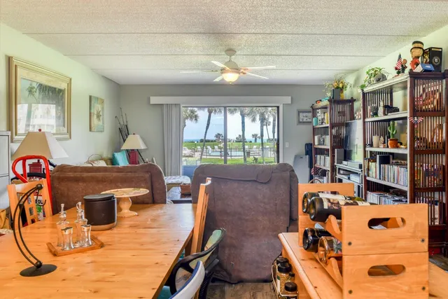 a living room with lots of furniture and a book shelf
