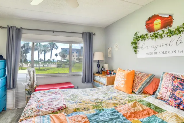 a bedroom with a bed and glass window