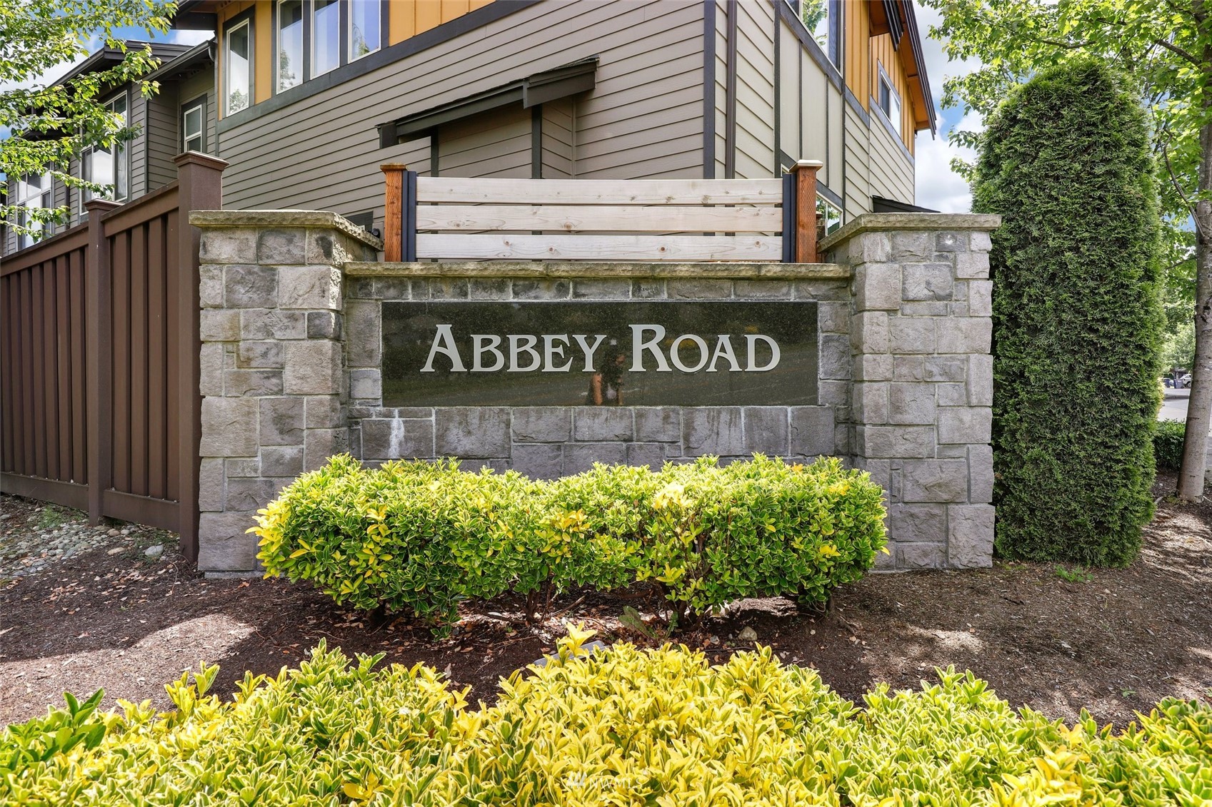221 164th Place Southeast Bothell, WA 98012 - Photo 2 of 30 a sign broad in front of flowers