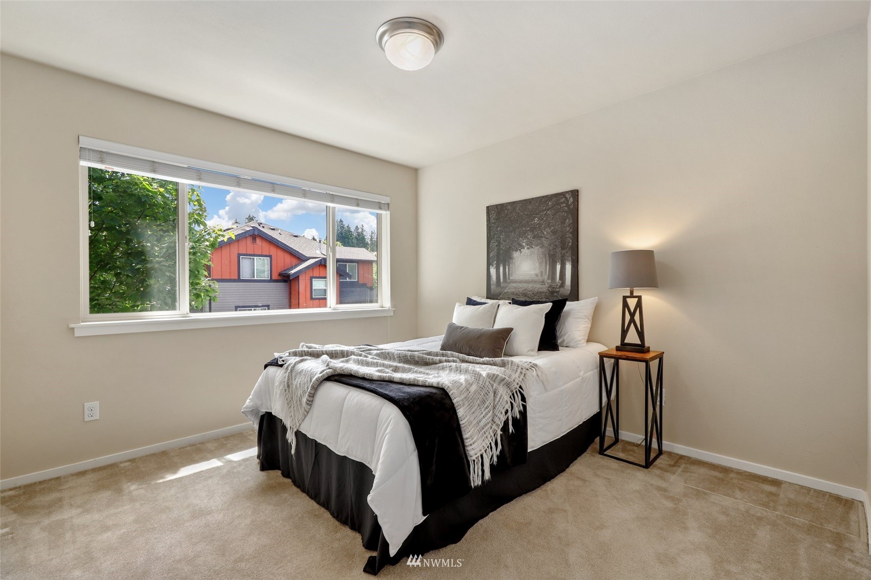 221 164th Place Southeast Bothell, WA 98012 - Photo 22 of 30 a bedroom with a bed lamp and window