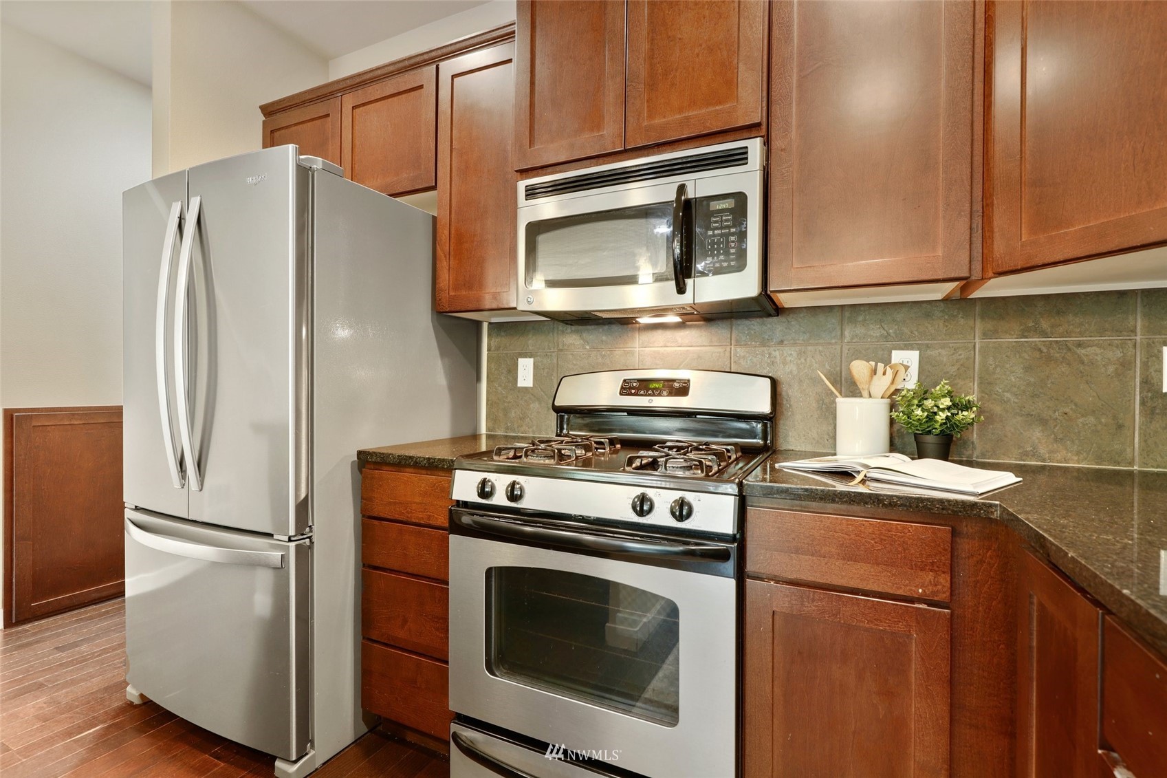 221 164th Place Southeast Bothell, WA 98012 - Photo 10 of 30 a kitchen with stainless steel appliances granite countertop a refrigerator stove and microwave