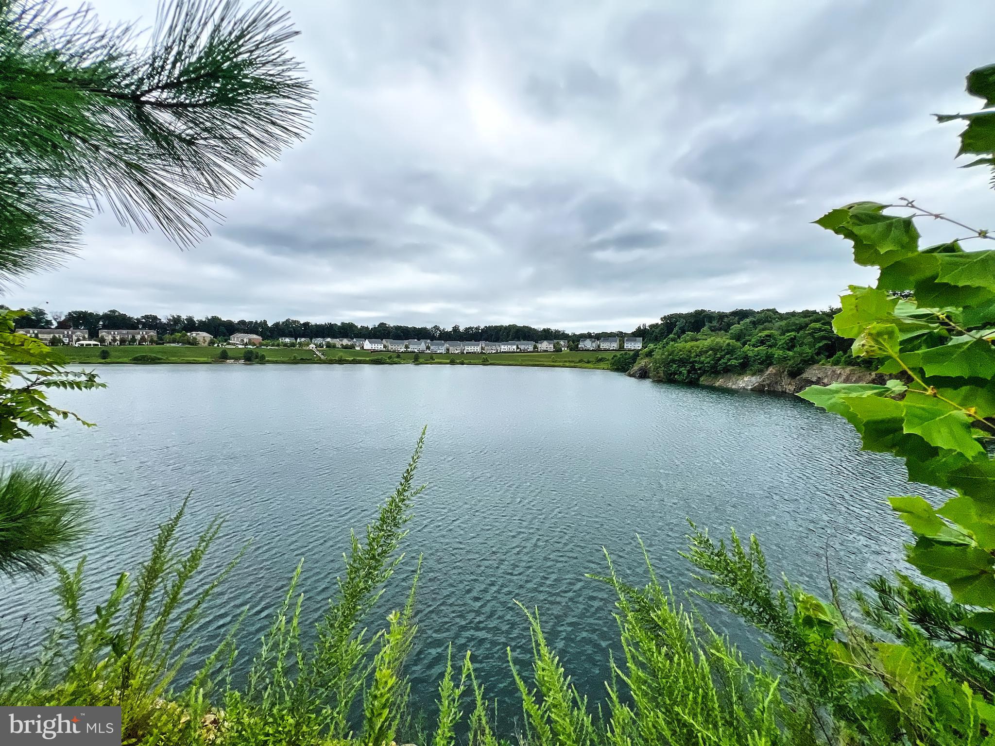 605 Quarry View Court, Unit 307 Reisterstown, MD 21136 - Photo 27 of 30 a view of a lake with houses in the back