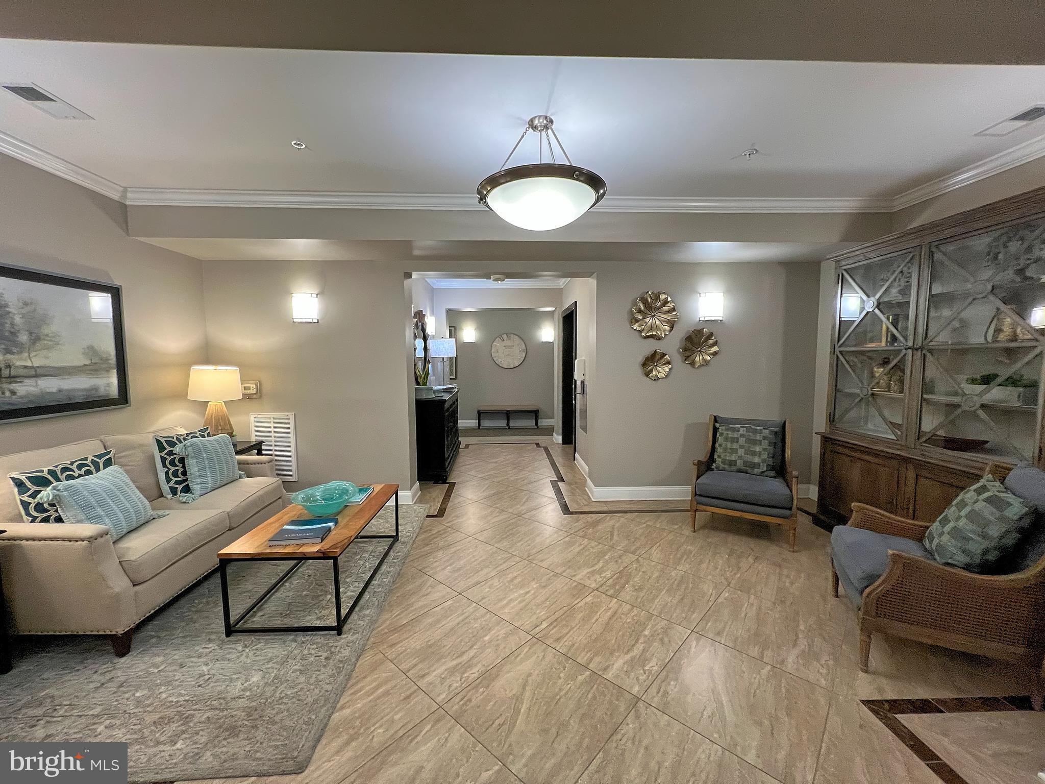 605 Quarry View Court, Unit 307 Reisterstown, MD 21136 - Photo 3 of 30 a living room with furniture and a flat screen tv