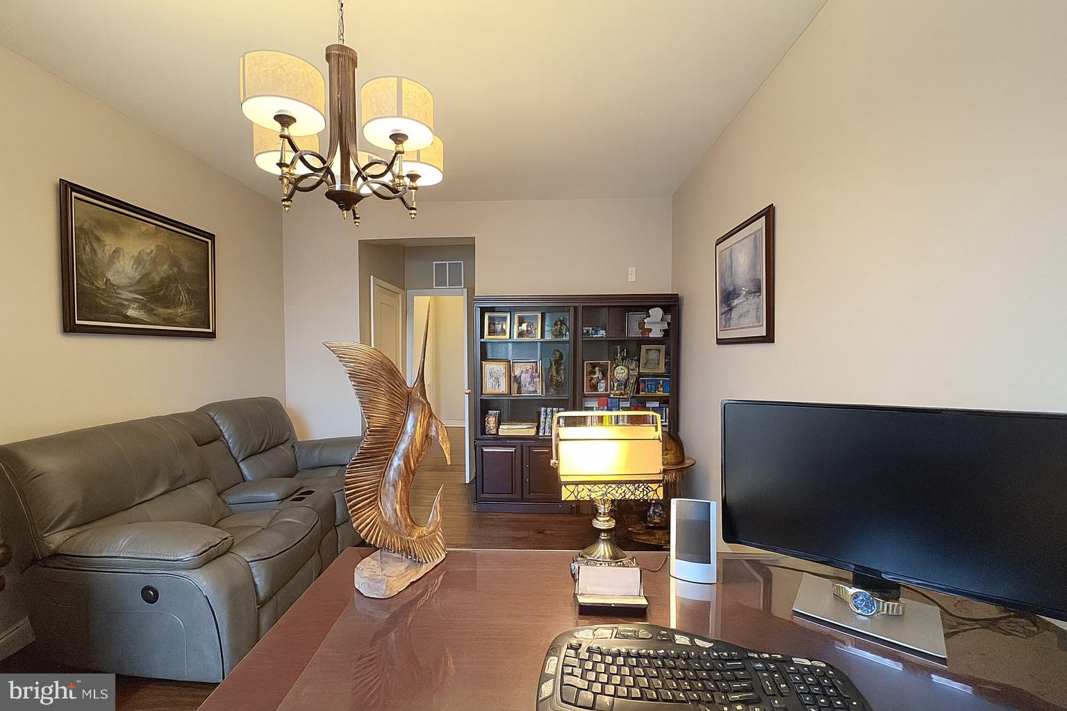 605 Quarry View Court, Unit 307 Reisterstown, MD 21136 - Photo 6 of 30 a living room with furniture a flat screen tv and a chandelier