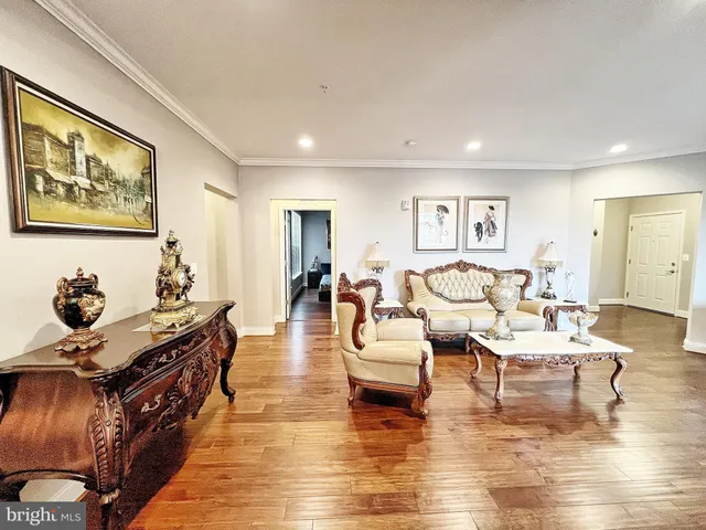 a living room with fireplace furniture and wooden floor