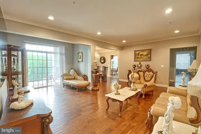 a living room with furniture rug and wooden floor