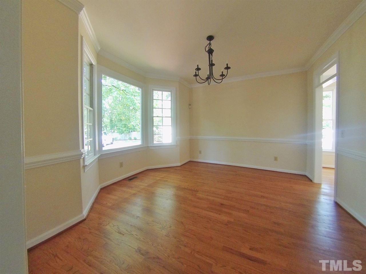 3312 Wade Avenue Raleigh, NC 27607 - Photo 4 of 13 an empty room with wooden floor and windows
