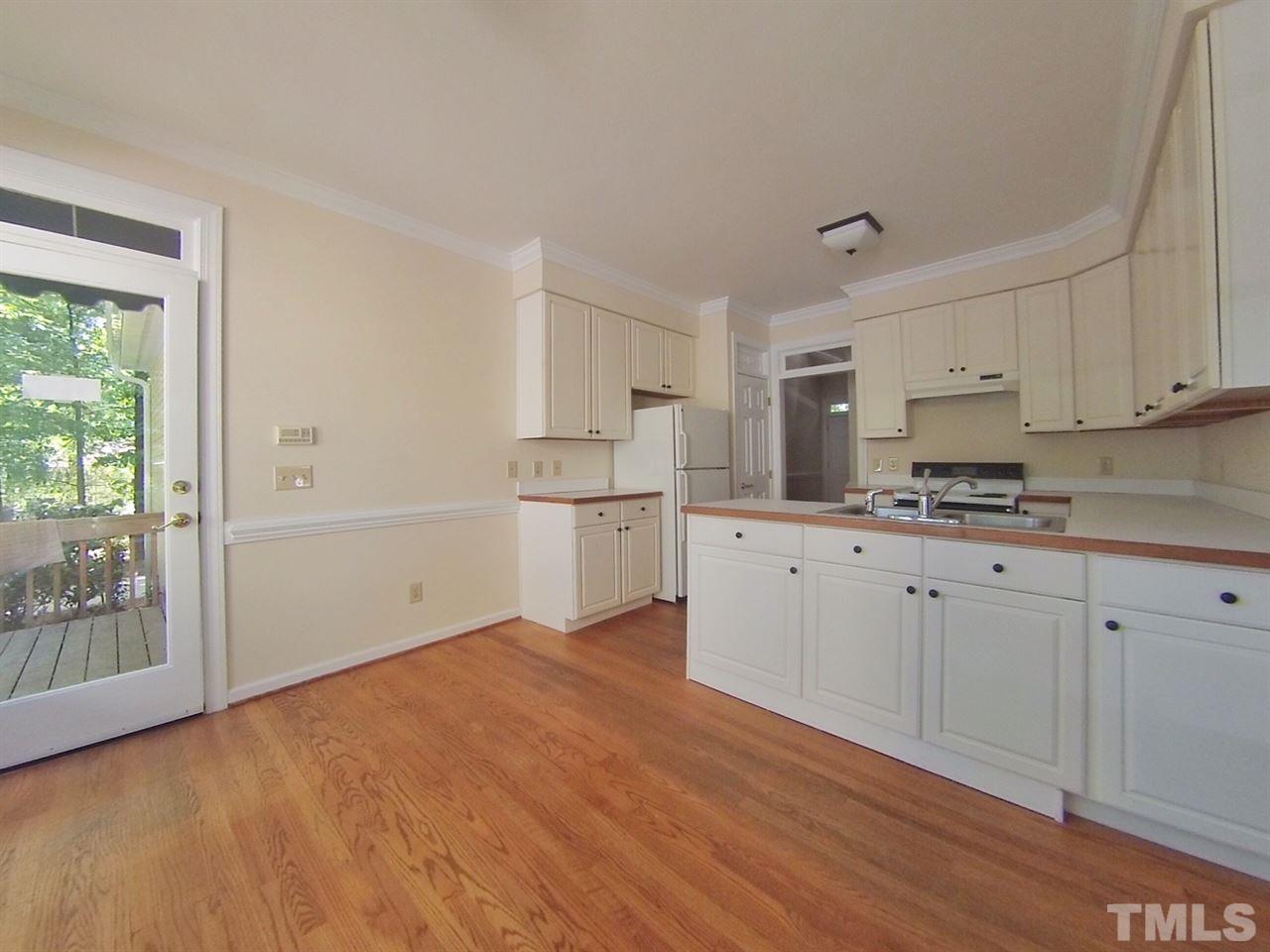 3312 Wade Avenue Raleigh, NC 27607 - Photo 5 of 13 a kitchen with granite countertop white cabinets and white appliances