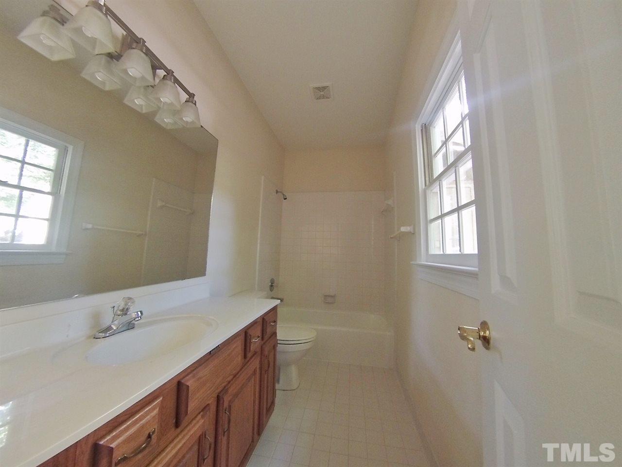 3312 Wade Avenue Raleigh, NC 27607 - Photo 10 of 13 a bathroom with 2 sink tub and a mirror