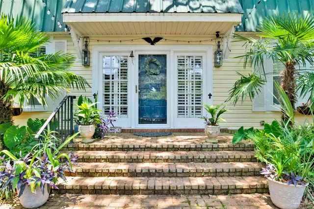 a front view of a house with a garden