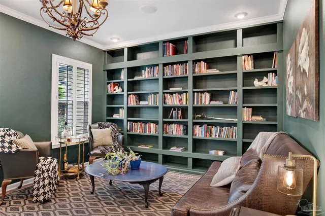 a living room with furniture and a book shelf