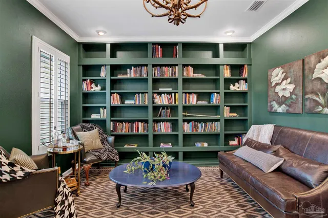 a living room with furniture and a book shelf