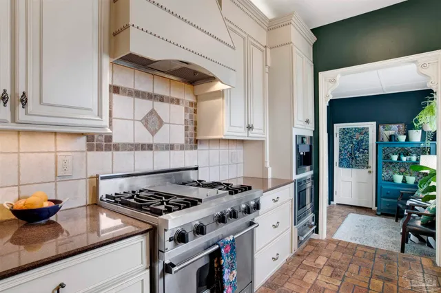 a kitchen with granite countertop a stove and a sink
