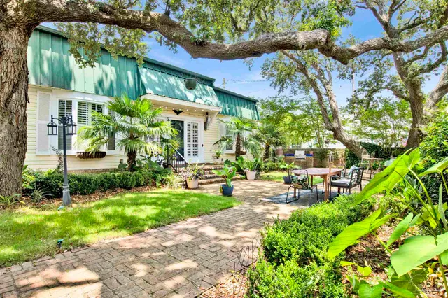 a front view of a house with garden