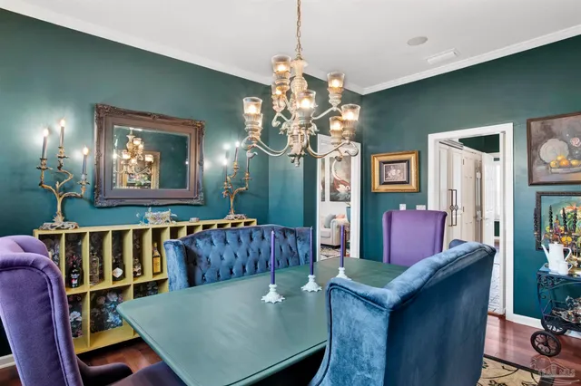 a living room with furniture a chandelier and a window